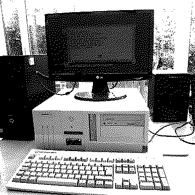 beige desktop computer sitting on a table, with a modern LCD monitor on top